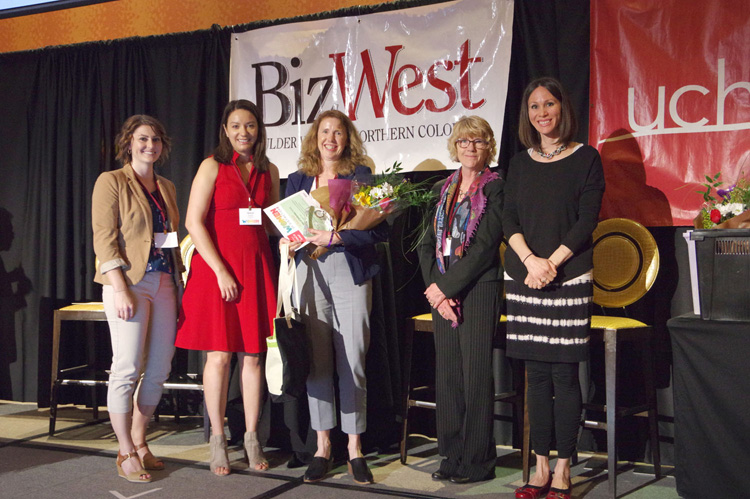 A group of women with flowers on stage