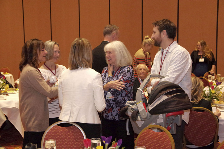 Guests standing and talking after the program