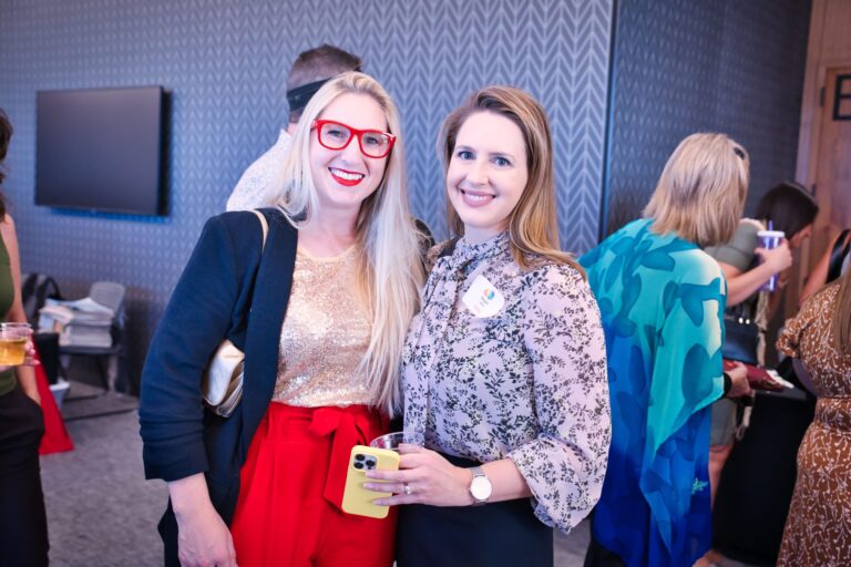 Two women smiling together in the hall