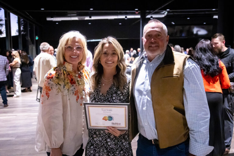 Three guests posing with a certificate