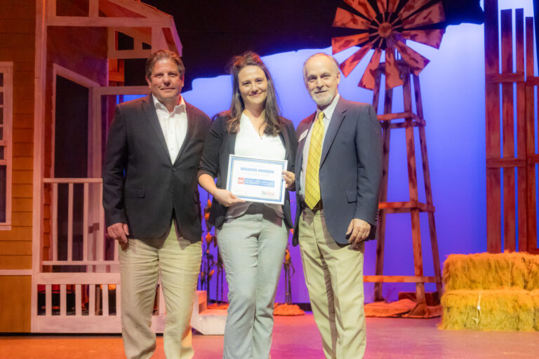 Honorees on stage holding an award at the 2025 Most-Influential Business Leaders event