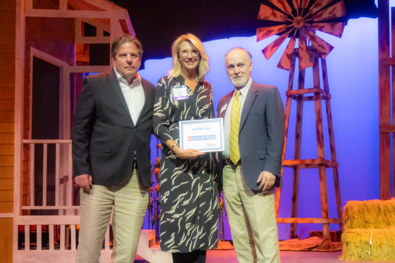 Honorees on stage holding an award at the 2025 Most-Influential Business Leaders event