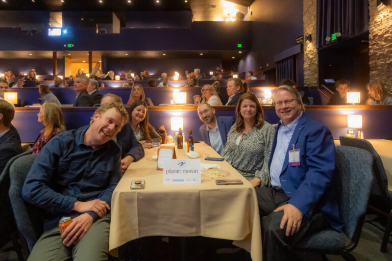 Guests at a table applaud during the 2025 program