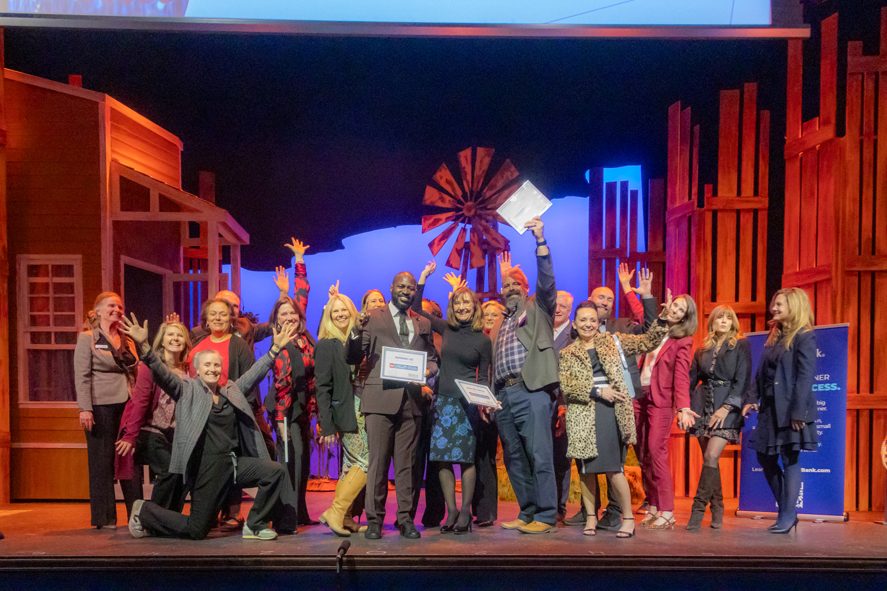 Honorees celebrate on stage at the 2025 Most-Influential Business Leaders event at Candlelight Dinner Theater