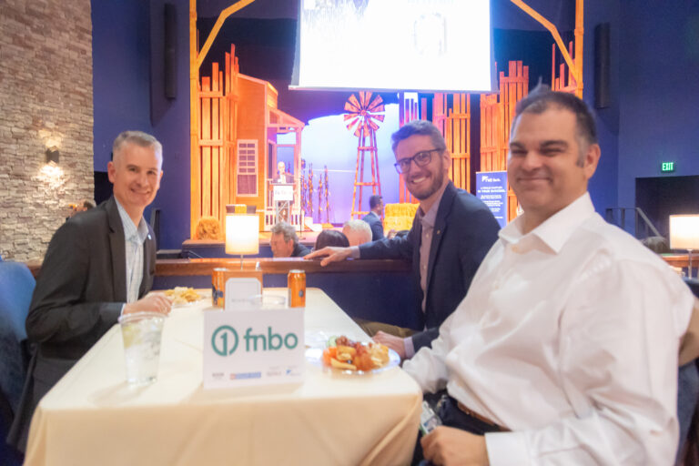 Guests seated at a table with an FNBO sign at the 2025 event