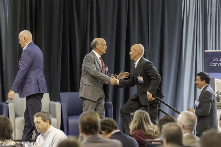 Speakers greeting on stage before the panel at the 2026 Northern Colorado Economic Forecast