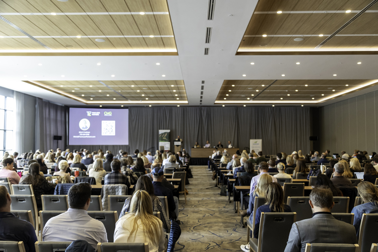 The audience and panel in the Limelight Hotel ballroom in 2025