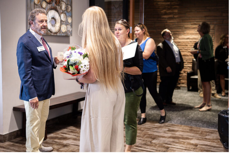 A guest receiving flowers at the reception