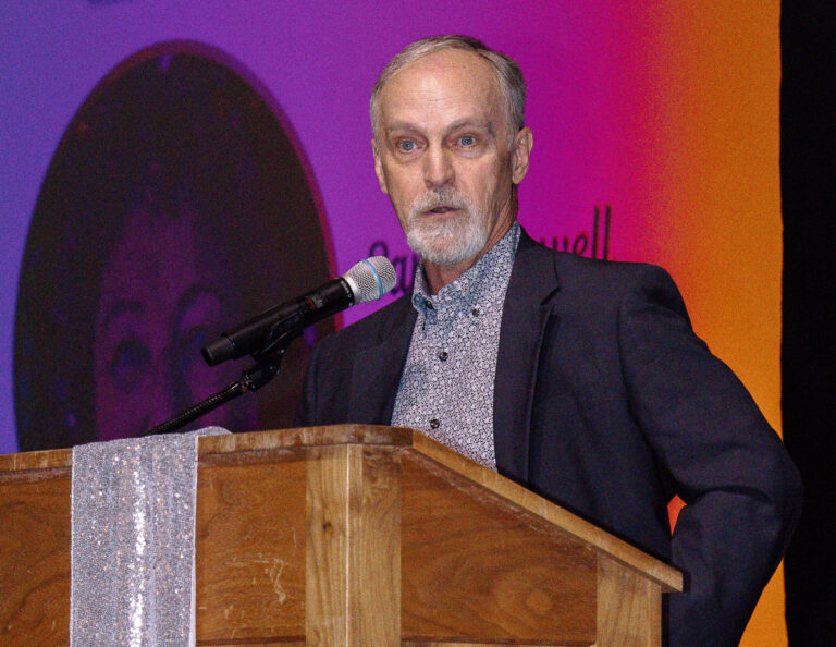 A presenter speaking at the podium