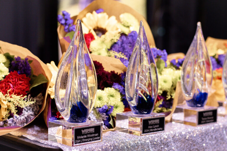 The glass awards and bouquets lined up on a table