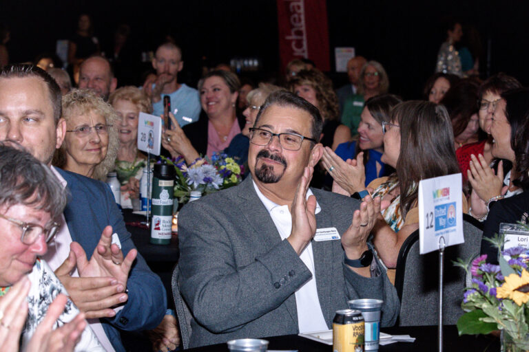 The audience applauding at their tables