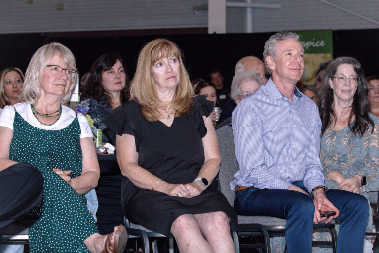 Guests seated in the audience, smiling