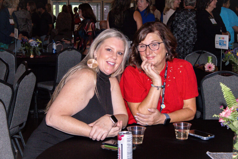 Two guests smiling at their table