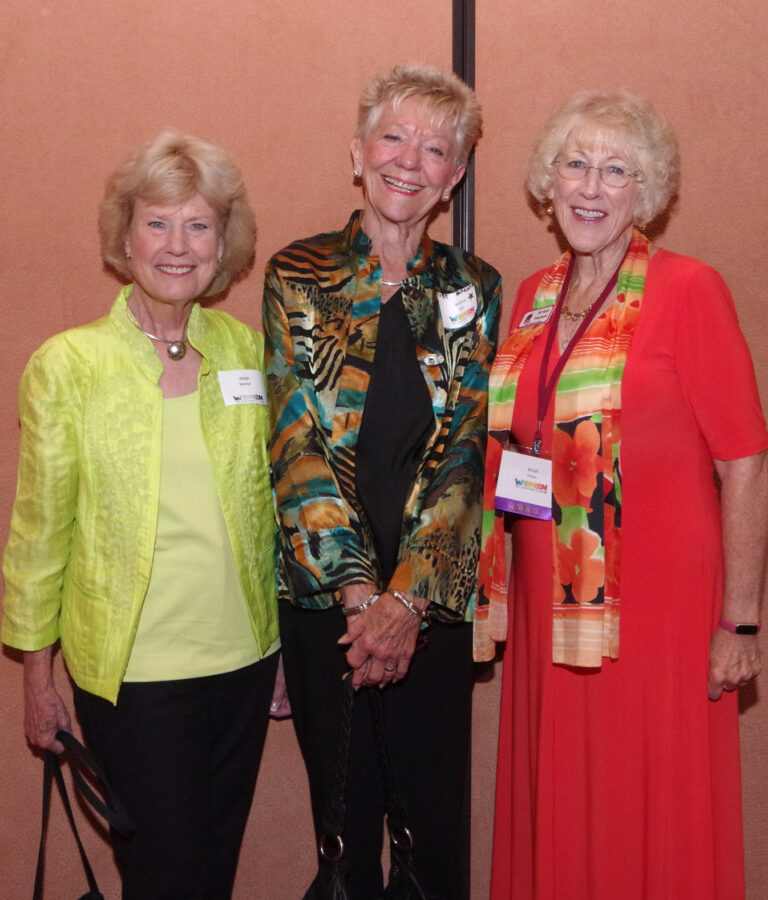 Three guests posing together at the reception