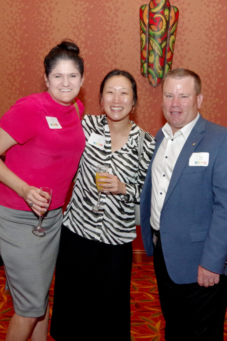 Three guests posing together at the reception