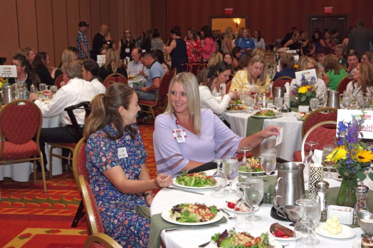 Guests seated at round tables during the event