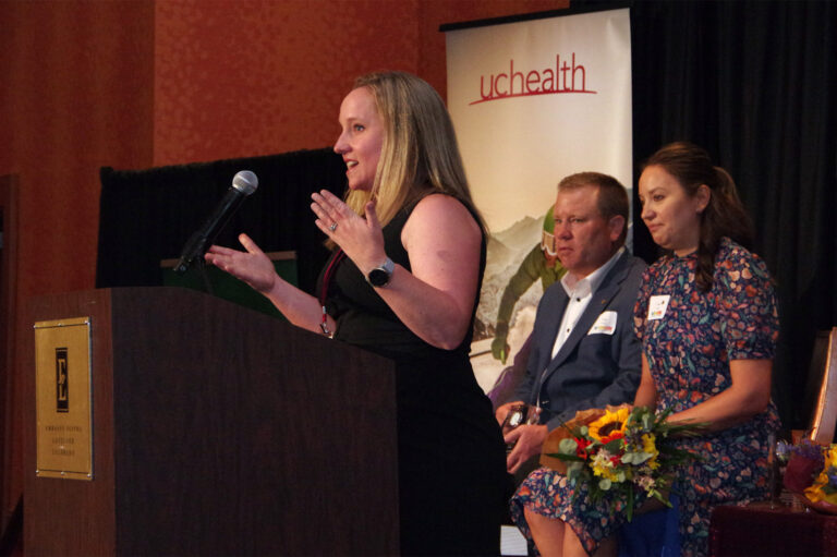 A speaker at the podium addressing the room
