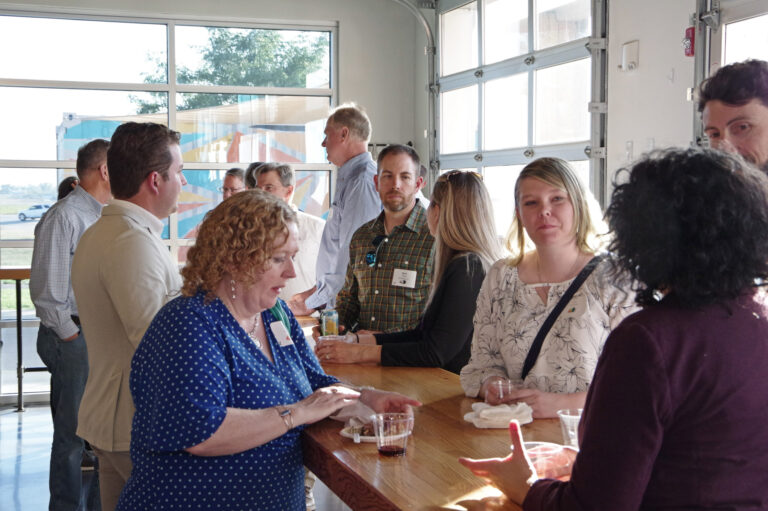 Guests talking by the windows during the reception