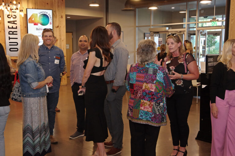 Guests mingling beside an Outreach sign