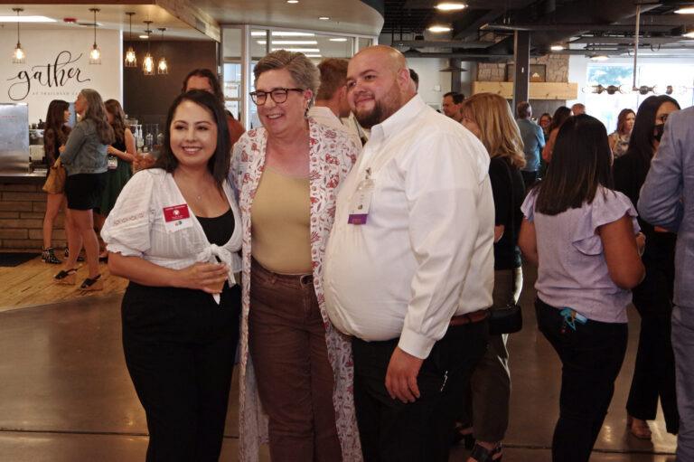 Three guests posing together during the reception