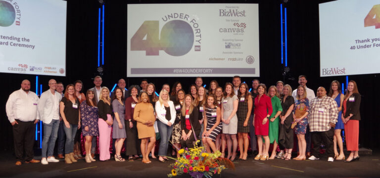 A second large group on stage beneath the 40 Under Forty screen