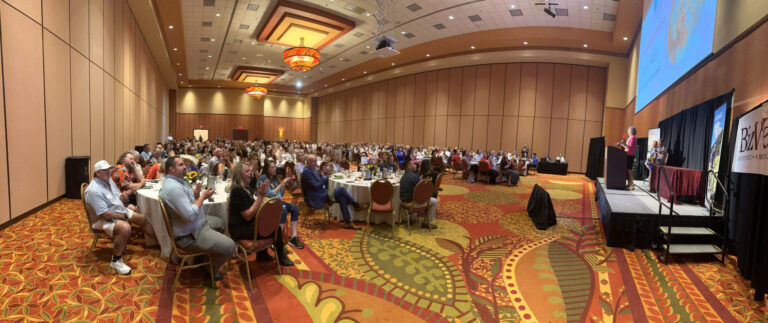 A wide view of the ballroom during the program